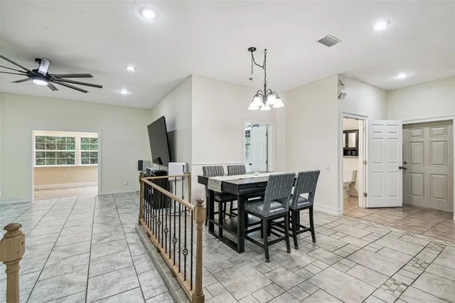a view of walk in closet with window and a ceiling fan