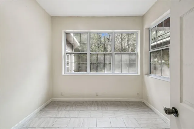 a large white bathroom with a granite countertop sink a toilet and bathtub