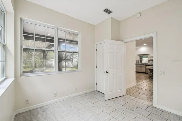 a view of a livingroom with wooden floor and a ceiling fan
