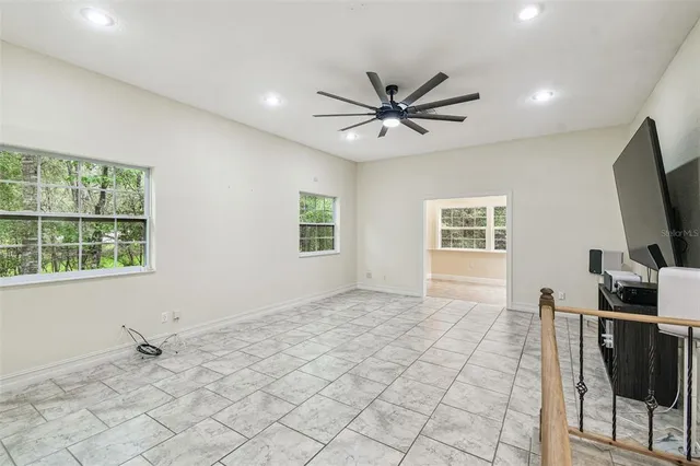a front view of a house with a yard and swimming pool