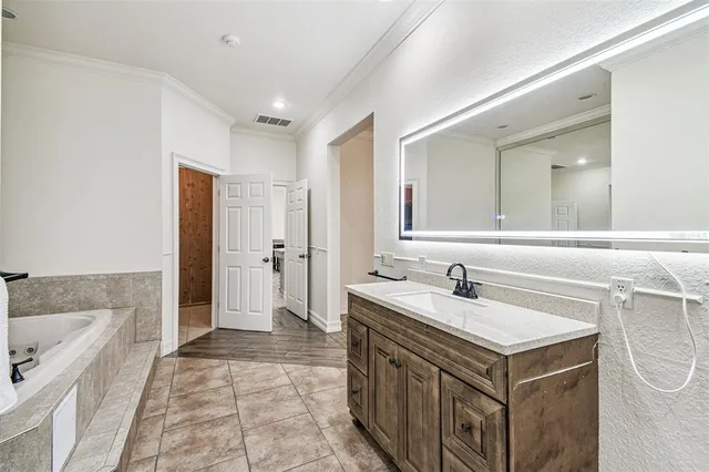 a spacious bathroom with a sink a toilet and a mirror