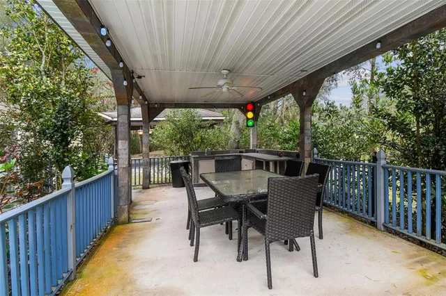a view of a big yard with plants and large trees