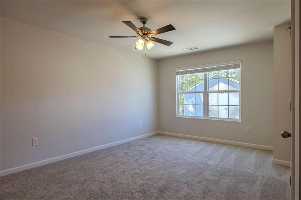 21 Sweetspire Drive Rome, GA 30165 - Photo 12 of 22 an empty room with ceiling fan and windows