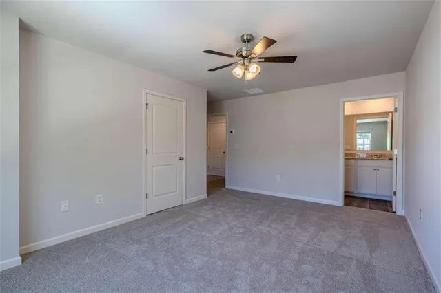a view of an empty room and closet area