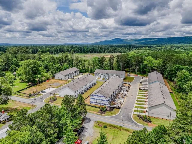 an aerial view of a house with garden space and street view