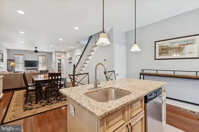 a kitchen with a table chairs and a wooden floor