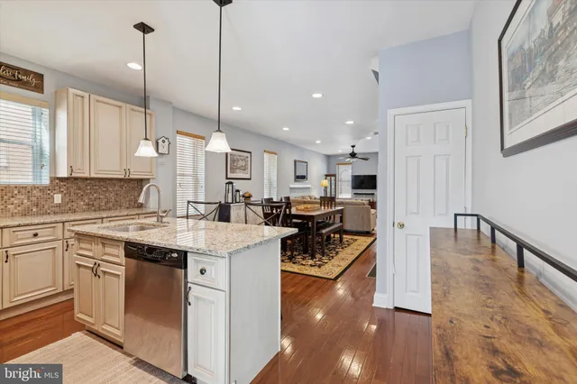 a kitchen with stove a sink and refrigerator