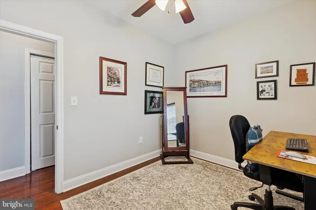 a view of a workspace with furniture and wooden floor