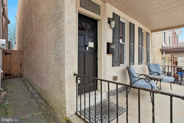 a view of staircase with railing and white walls