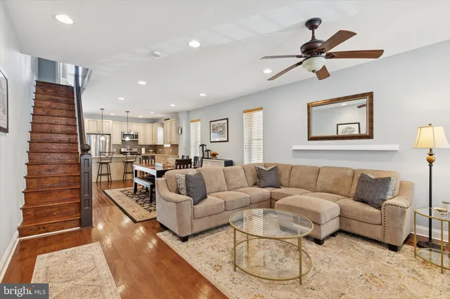 a living room with furniture and a view of kitchen