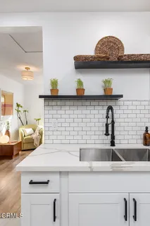 a kitchen with a sink and cabinets