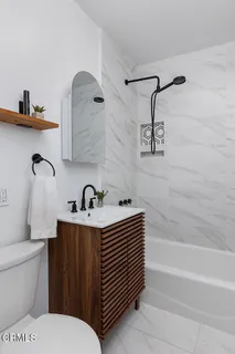 a view of a patio with table and chairs potted plants and large tree