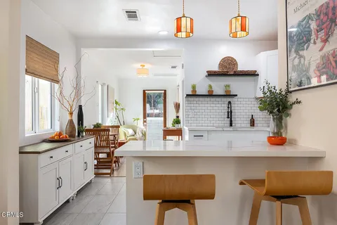 a kitchen with stainless steel appliances granite countertop a stove and white cabinets