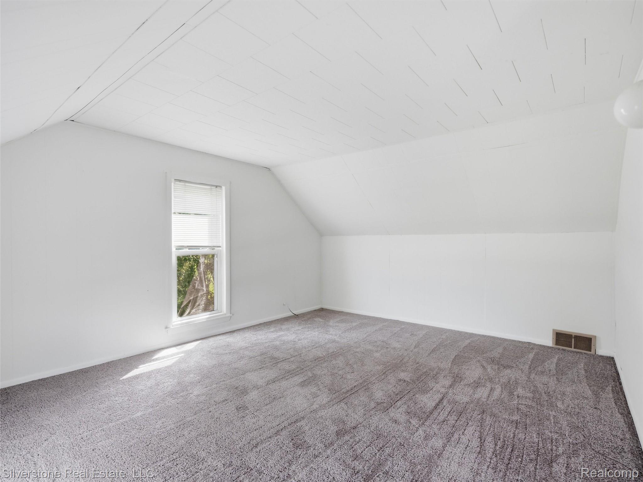 9691 Grames Road Maybee, MI 48159 - Photo 27 of 44 Vaulted ceiling, wall-to-wall carpeting, single window, and a built-in light fixture
