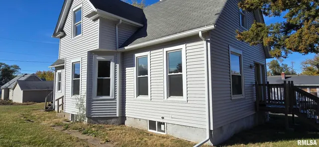 a view of a house with a yard and sitting space
