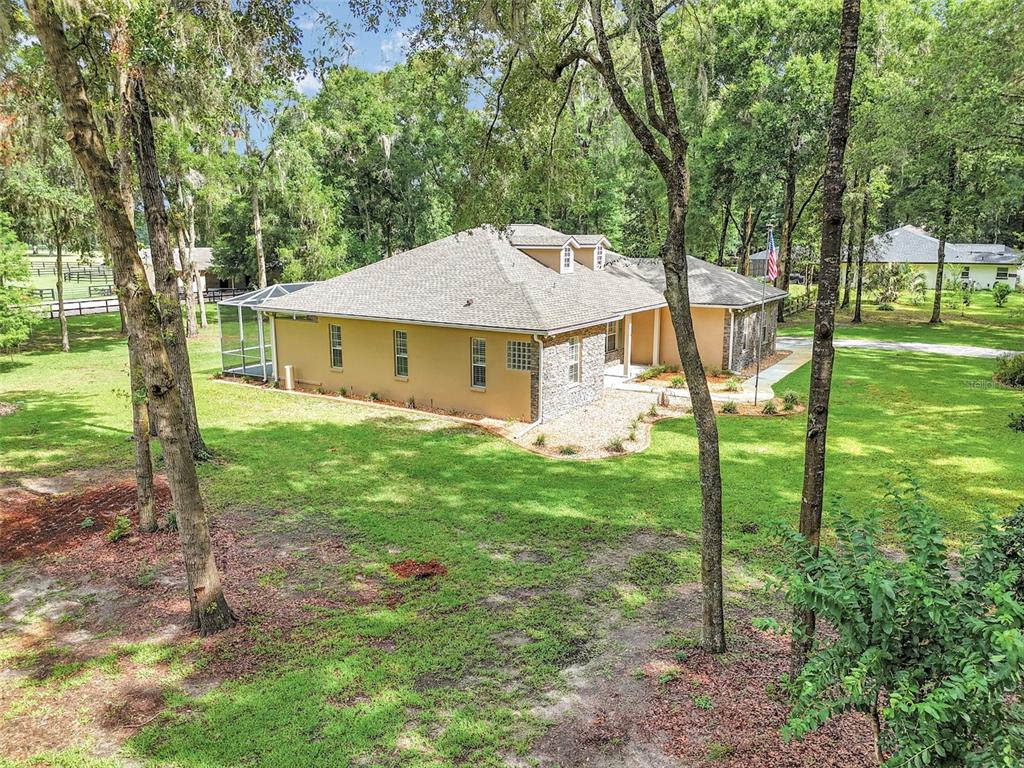 1989 Northwest 111th Loop Ocala, FL 34475 - Photo 40 of 55 a view of a house with backyard and a tree