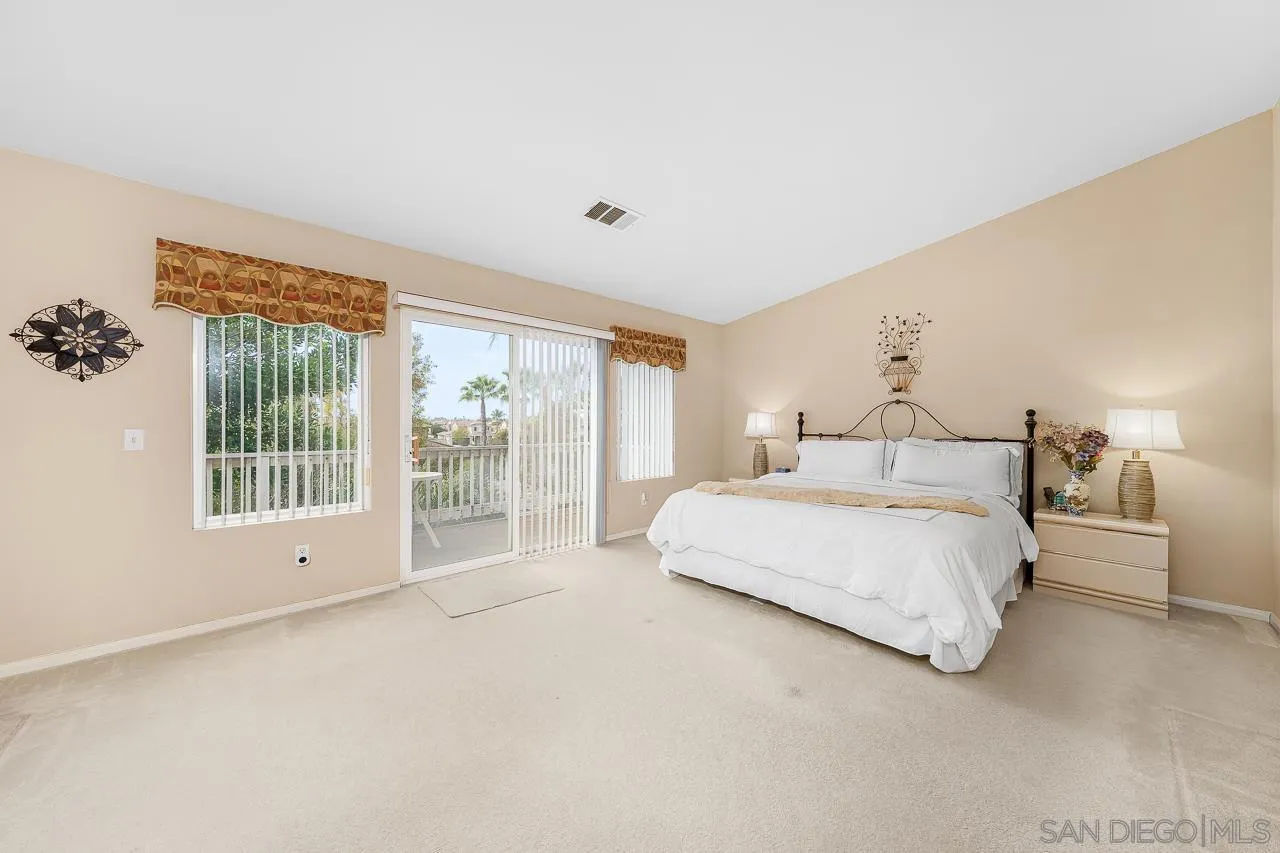 1559 Pleasanton Road Chula Vista, CA 91913 - Photo 16 of 41 a spacious bedroom with a large bed and a large window