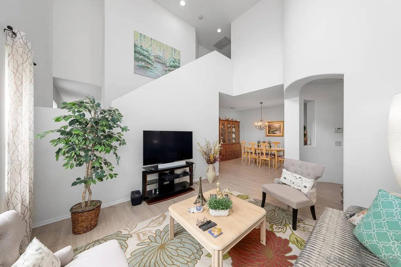 1559 Pleasanton Road Chula Vista, CA 91913 - Photo 2 of 41 a living room with furniture a flat screen tv and a potted plant