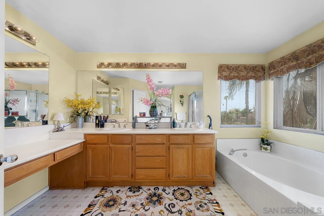 1559 Pleasanton Road Chula Vista, CA 91913 - Photo 22 of 41 a spacious bathroom with a tub sink and mirror