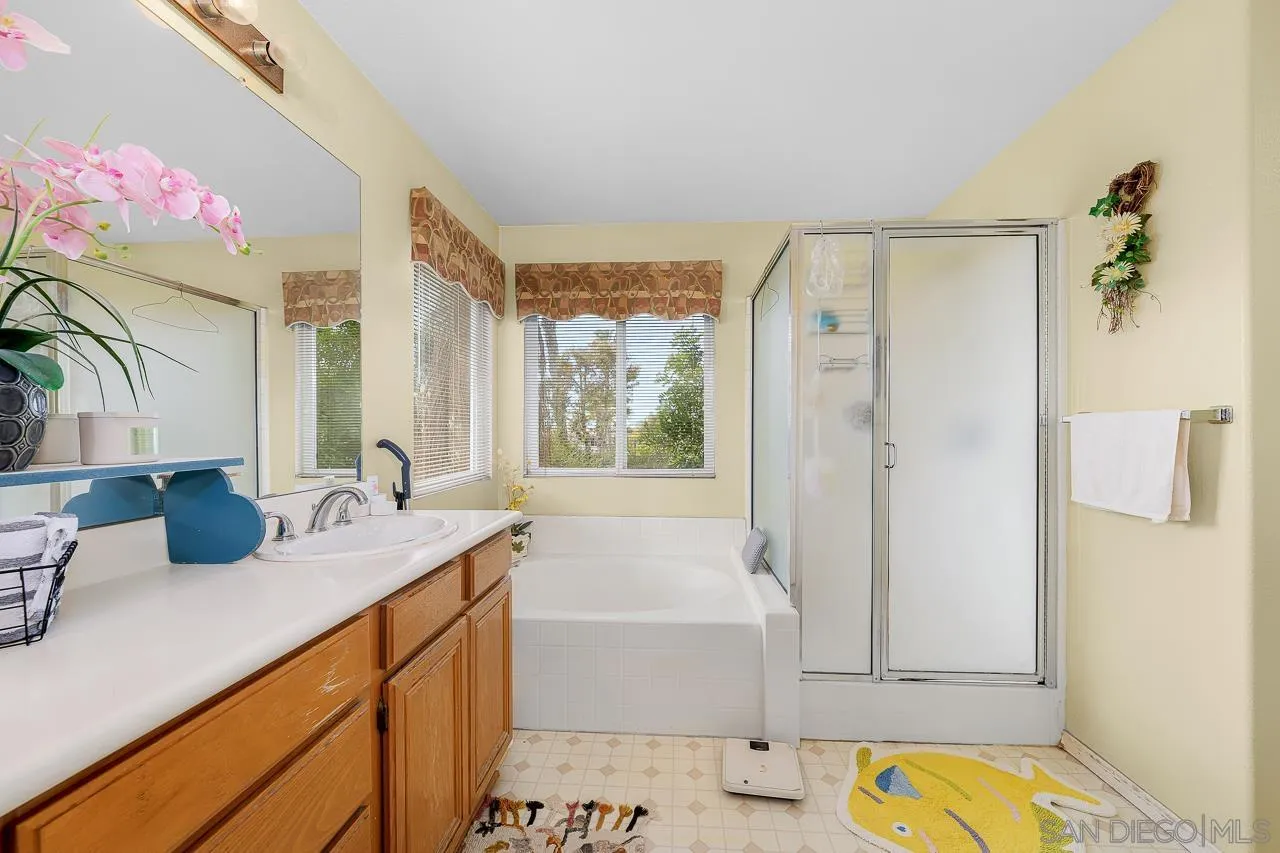 1559 Pleasanton Road Chula Vista, CA 91913 - Photo 23 of 41 a bathroom with a granite countertop tub sink and mirror
