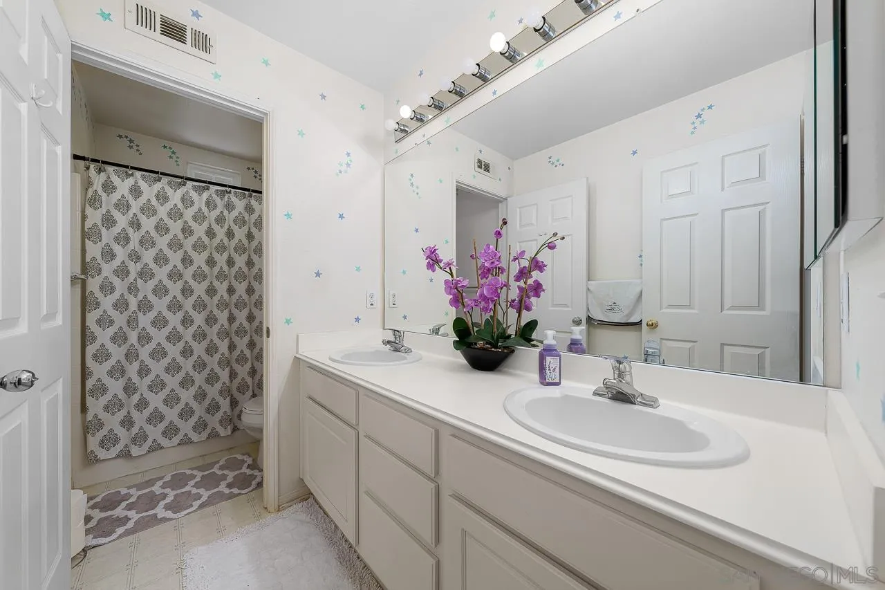 1559 Pleasanton Road Chula Vista, CA 91913 - Photo 26 of 41 a bathroom with a sink and a mirror