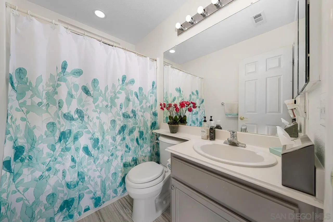 1559 Pleasanton Road Chula Vista, CA 91913 - Photo 34 of 41 a bathroom with a sink a toilet and a mirror