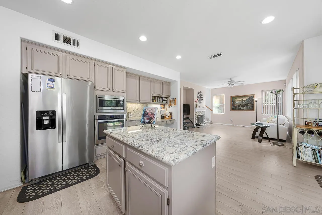 1559 Pleasanton Road Chula Vista, CA 91913 - Photo 8 of 41 a kitchen with stainless steel appliances granite countertop a refrigerator and a sink