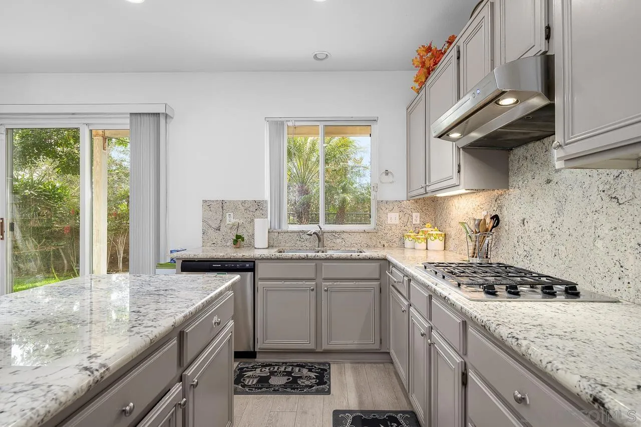 1559 Pleasanton Road Chula Vista, CA 91913 - Photo 9 of 41 a kitchen with stainless steel appliances granite countertop a sink stove and cabinets