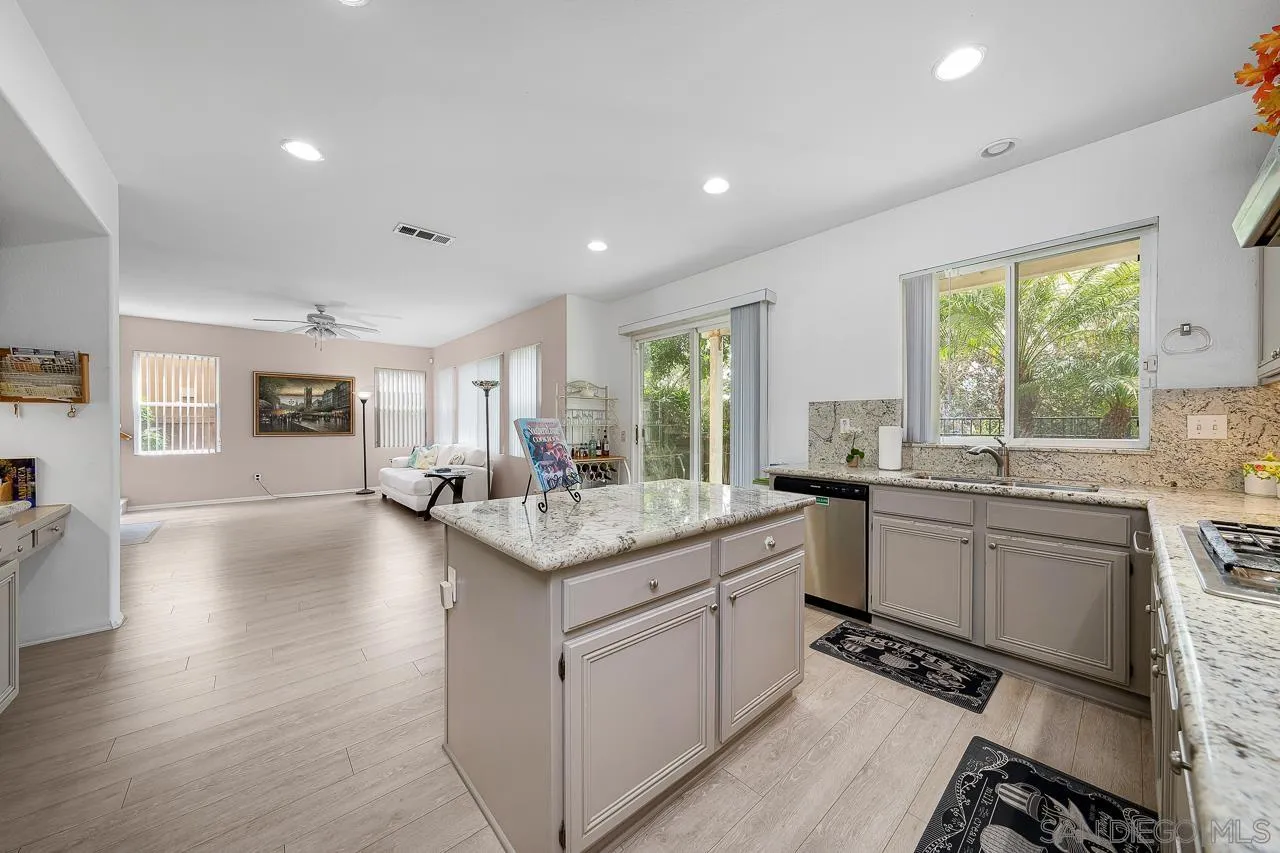 1559 Pleasanton Road Chula Vista, CA 91913 - Photo 10 of 41 a kitchen with sink cabinets and wooden floor