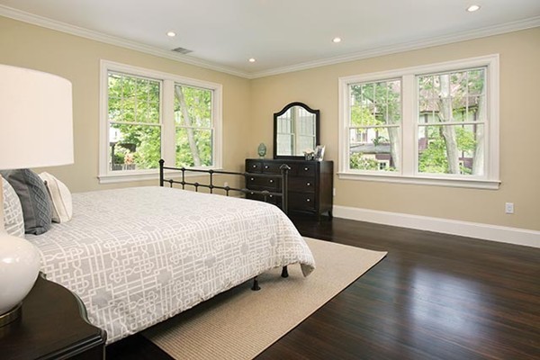 85 Dean Road Brookline, MA 02445 - Photo 10 of 12 a bedroom with a bed and wooden floor