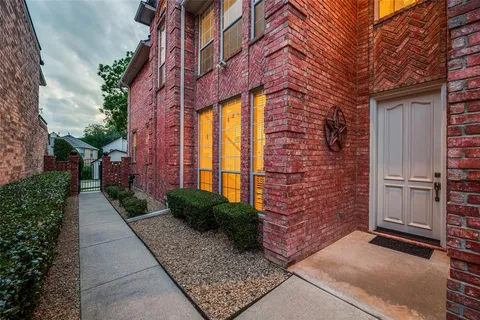 a view of a brick house with a yard