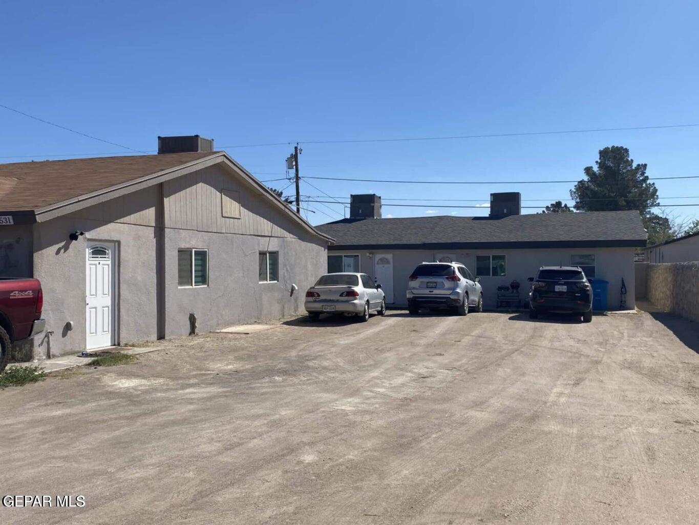a front view of a house with cars