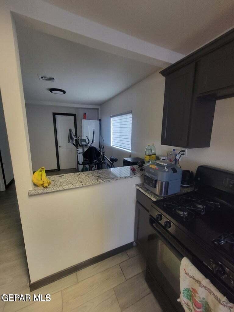 11531 Ernest Road, Unit 13 Socorro, TX 79927 - Photo 13 of 36 a kitchen with a sink and a stove top oven