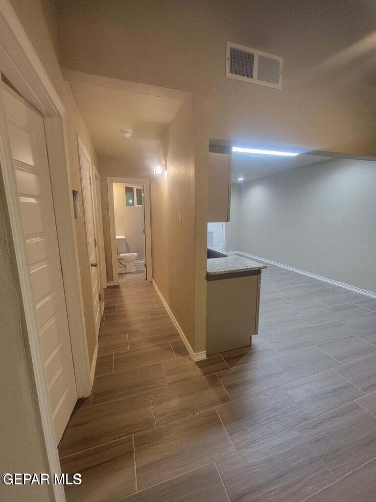 11531 Ernest Road, Unit 13 Socorro, TX 79927 - Photo 14 of 36 a view of a hallway with wooden cabinets