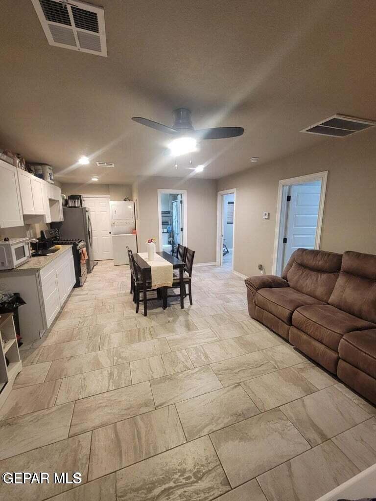 11531 Ernest Road, Unit 13 Socorro, TX 79927 - Photo 19 of 36 a living room with furniture and a view of kitchen