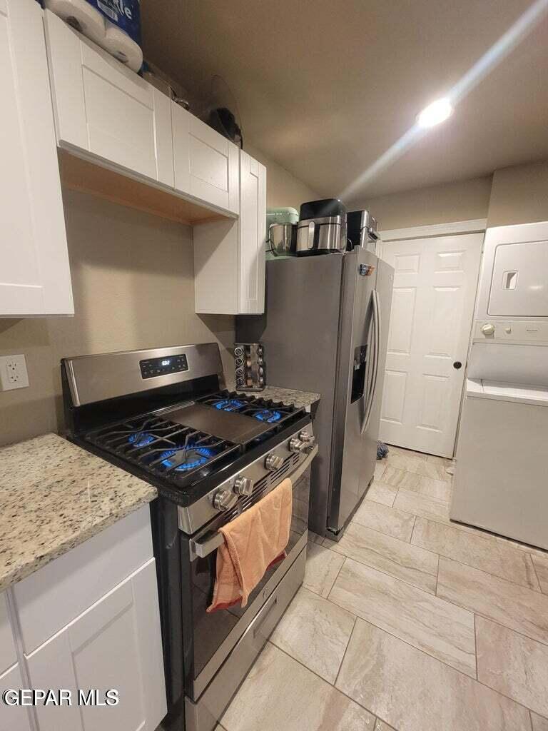 11531 Ernest Road, Unit 13 Socorro, TX 79927 - Photo 25 of 36 a kitchen with a stove and a refrigerator