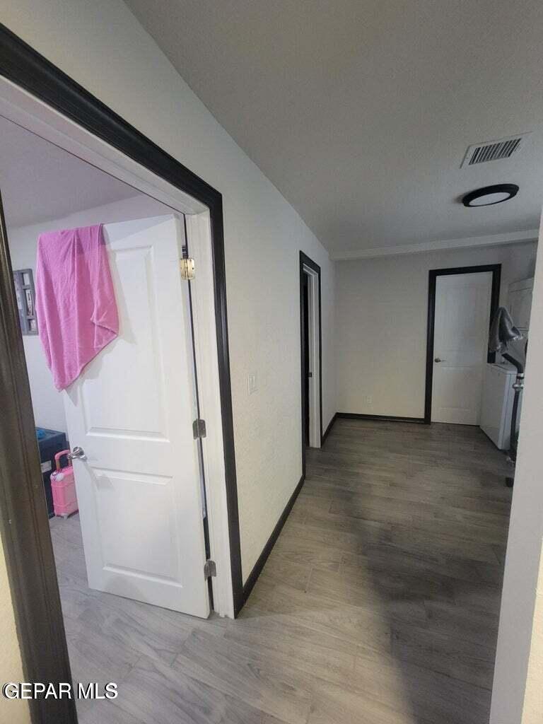 11531 Ernest Road, Unit 13 Socorro, TX 79927 - Photo 34 of 36 a view of a hallway with wooden floor and closet