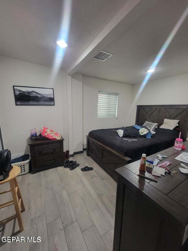 11531 Ernest Road, Unit 13 Socorro, TX 79927 - Photo 36 of 36 a bedroom with a bed and a potted plant