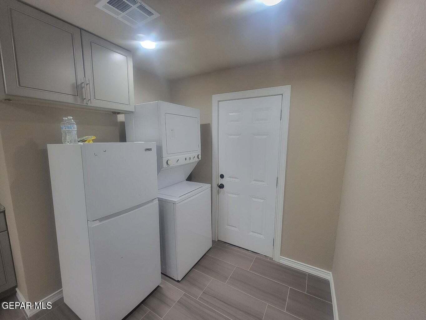 11531 Ernest Road, Unit 13 Socorro, TX 79927 - Photo 4 of 36 a view of cabinets and washer dryer