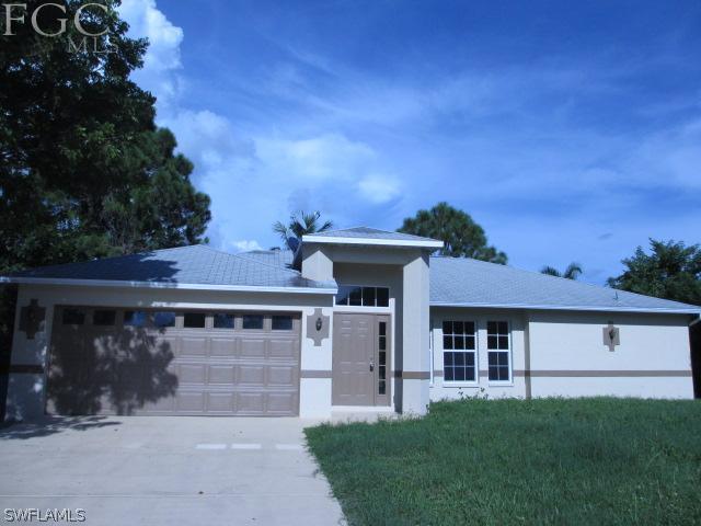17421 Lee Road Fort Myers, FL 33967 - Photo 1 of 13 a front view of a house with a yard