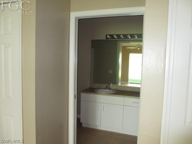 17421 Lee Road Fort Myers, FL 33967 - Photo 8 of 13 a bathroom with a granite countertop sink and a mirror