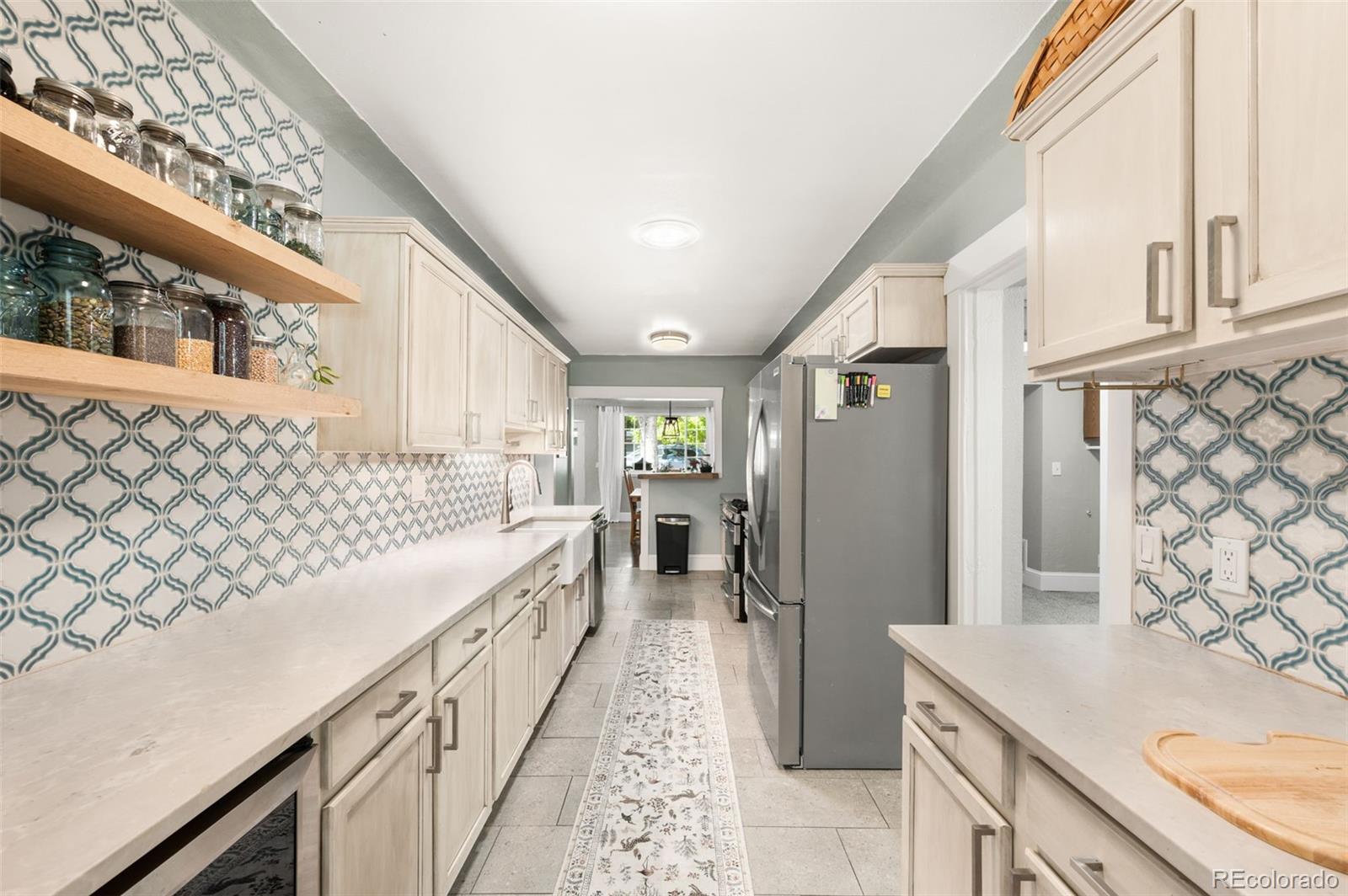 4730 Otis Street Wheat Ridge, CO 80033 - Photo 15 of 34 a view of a kitchen with a sink and wooden floor