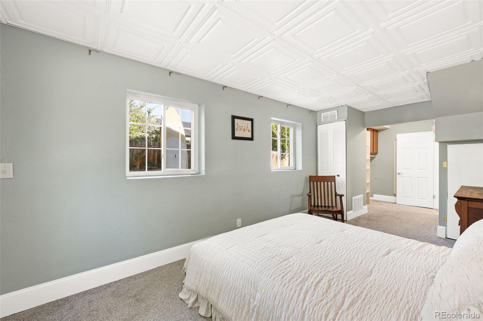 4730 Otis Street Wheat Ridge, CO 80033 - Photo 18 of 34 a bedroom with a bed and a window