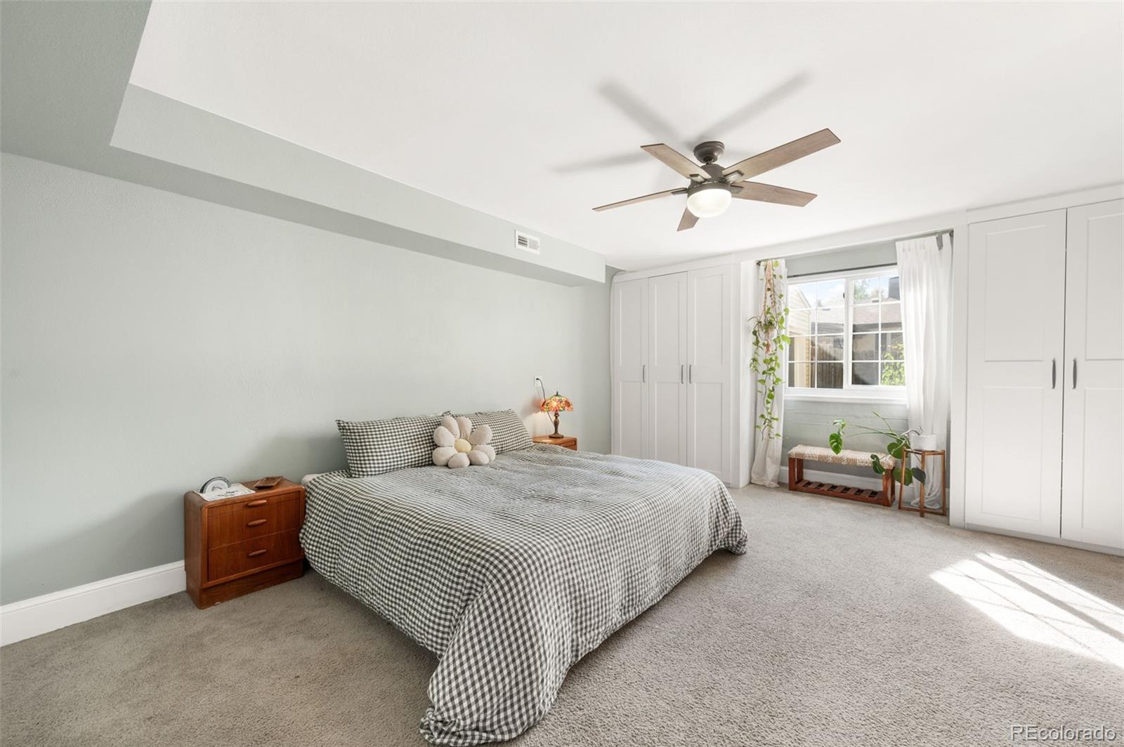 4730 Otis Street Wheat Ridge, CO 80033 - Photo 20 of 34 a bedroom with a bed and ceiling fan