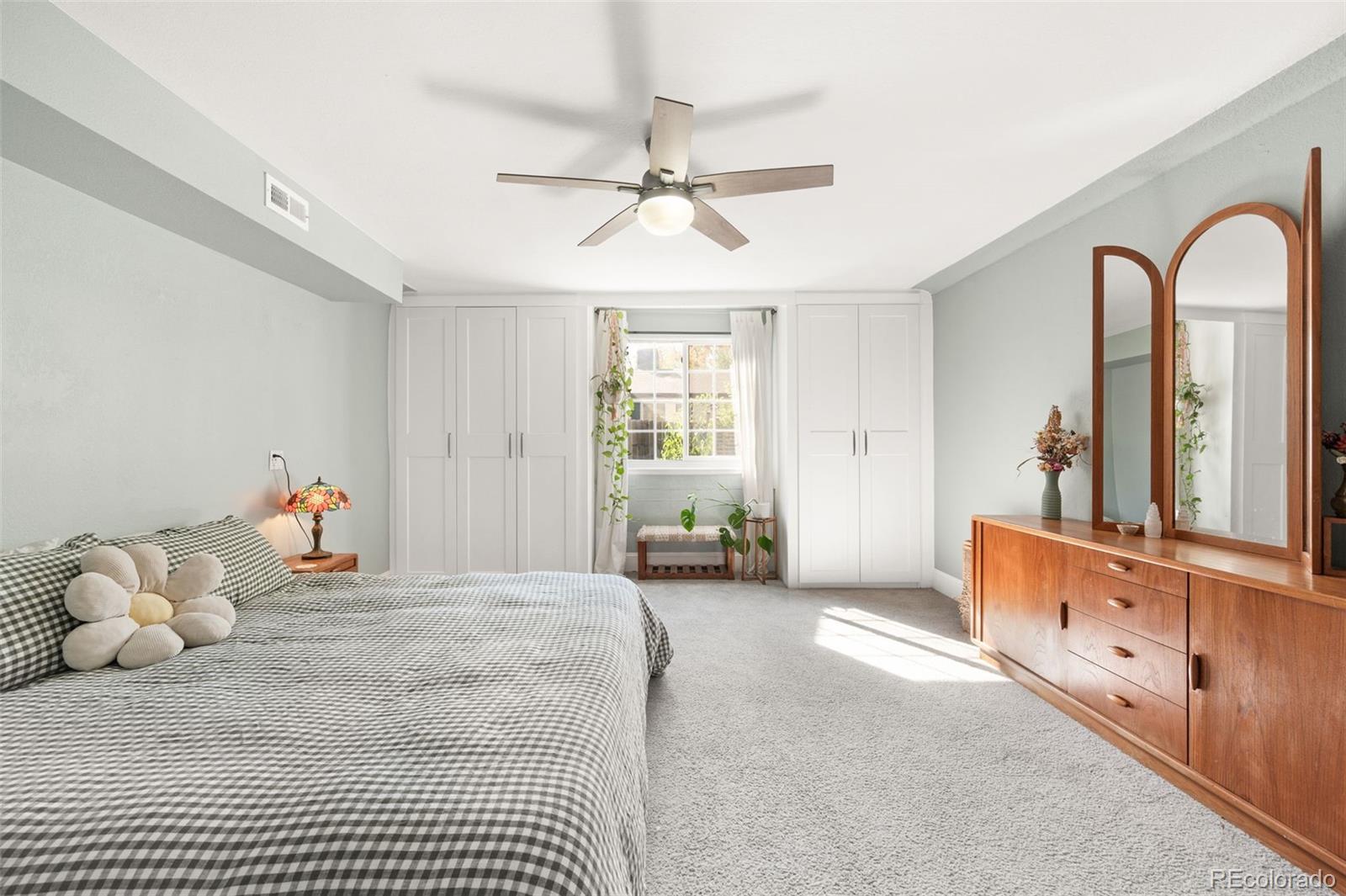 4730 Otis Street Wheat Ridge, CO 80033 - Photo 22 of 34 a bedroom with a bed and a chandelier