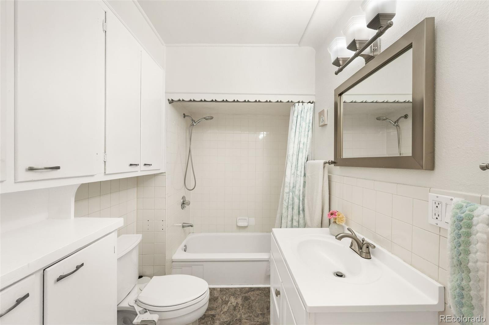 4730 Otis Street Wheat Ridge, CO 80033 - Photo 23 of 34 a bathroom with a sink toilet and shower