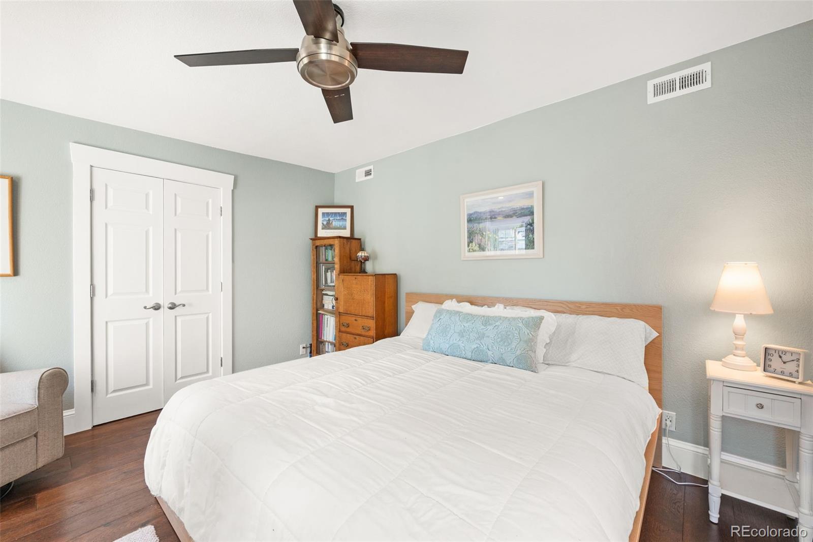 4730 Otis Street Wheat Ridge, CO 80033 - Photo 24 of 34 a bedroom with a bed and wooden floor