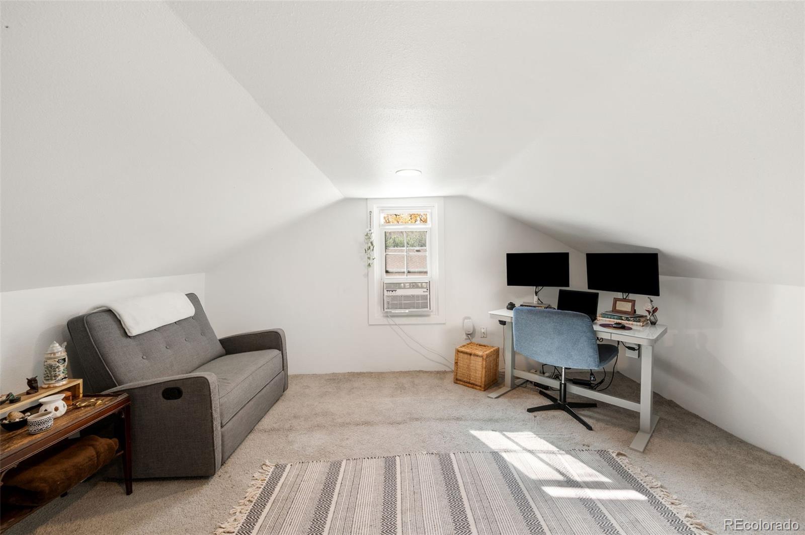 4730 Otis Street Wheat Ridge, CO 80033 - Photo 28 of 34 a living room with furniture a flat screen tv and a window