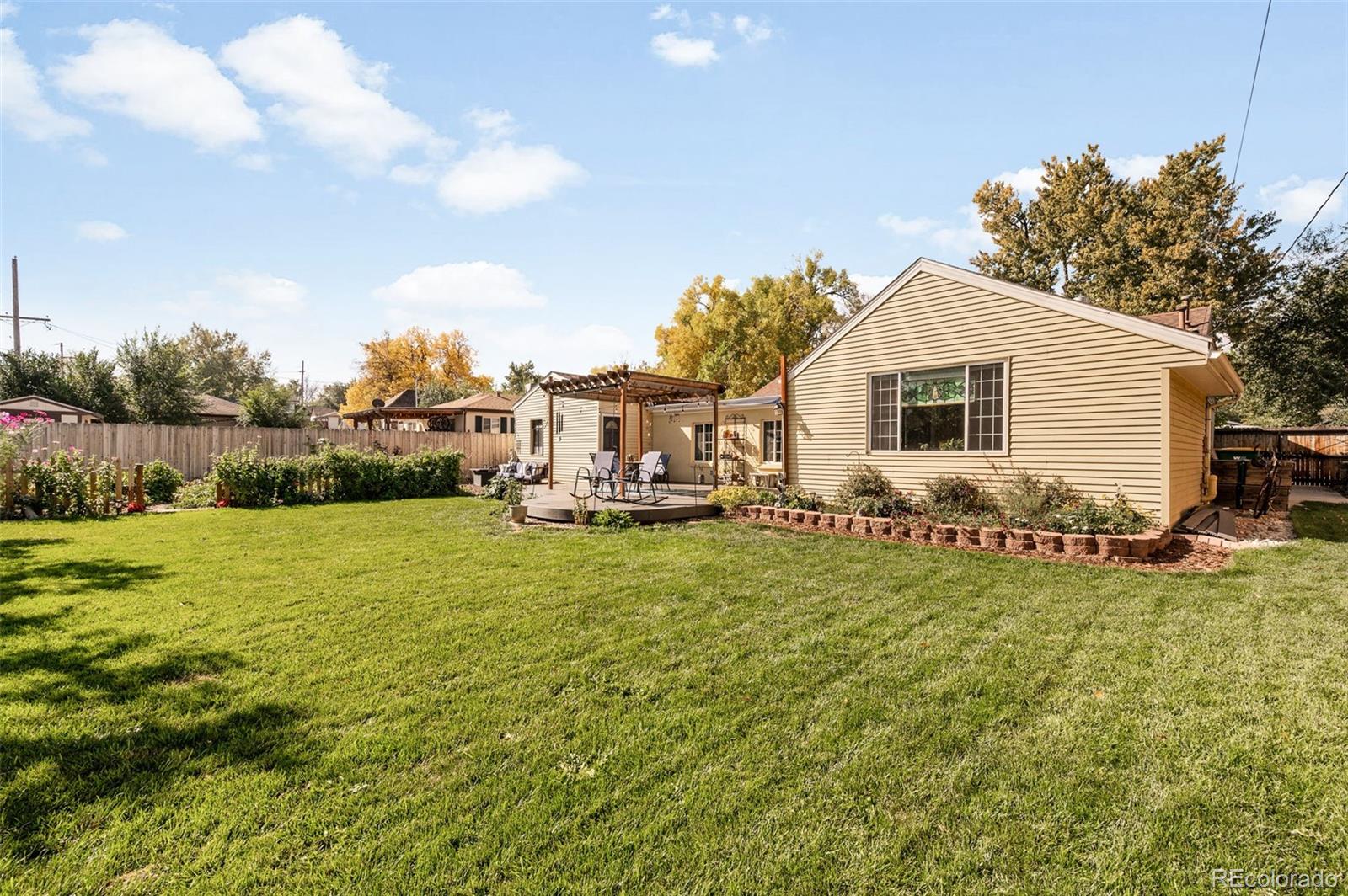4730 Otis Street Wheat Ridge, CO 80033 - Photo 30 of 34 a view of a house with backyard porch and garden