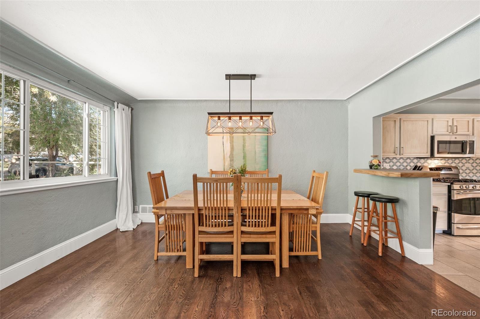 4730 Otis Street Wheat Ridge, CO 80033 - Photo 10 of 34 a view of a dining room with furniture window and wooden floor